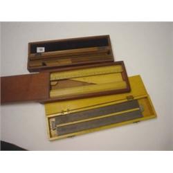 Box of twelve magnets plus two mahogany wooden rules