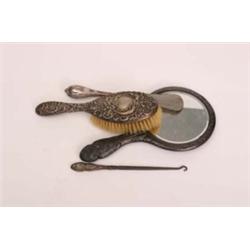 Silver hallmarked dressing table mirror embossed with cherubs plus silver backed brush, silver handl