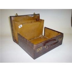 Small crocodile skin suitcase with brass mounts, internally fitted with compartments as attaché case