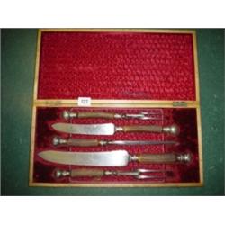 Boxed four piece carving set, Scottish horn handled with silver plated decoration set in red velvet,