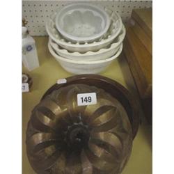 Four Victorian ceramic jelly moulds (all with some damage) plus similar copper one and T.G Green pie