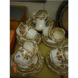 Decorative bone china tea service comprising of three tea plates, eleven saucers, ten cups and milk 