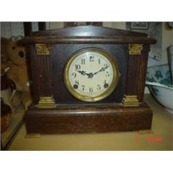 Clock: American oak cased mantle clock with brass movement in working order, 8 day  with small ormol