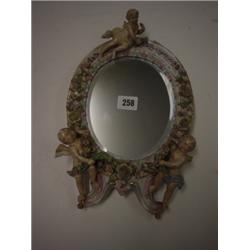 Late 19th century oval bevelled toilet mirror, frame decorated with applied porcelain flowers and ch