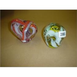 Two studio glass paperweights Bohemian and one other signed.