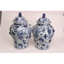 Pair of 18th century Chinese export blue and white baluster vases with covers, decorated with applie