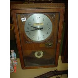 Oak cased time recorder with round barometer in the base Time recorder (Leeds) Ltd.