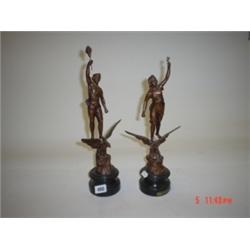 Two late 19th century spelter figures standing on eagles. Approx 14" high