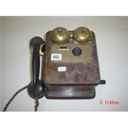 Old Brass wall mounted telephone with Oak box and bakalite handle box with ringing arm