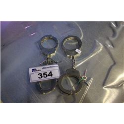 TWO PAIRS OF HANDCUFFS WITH KEYS