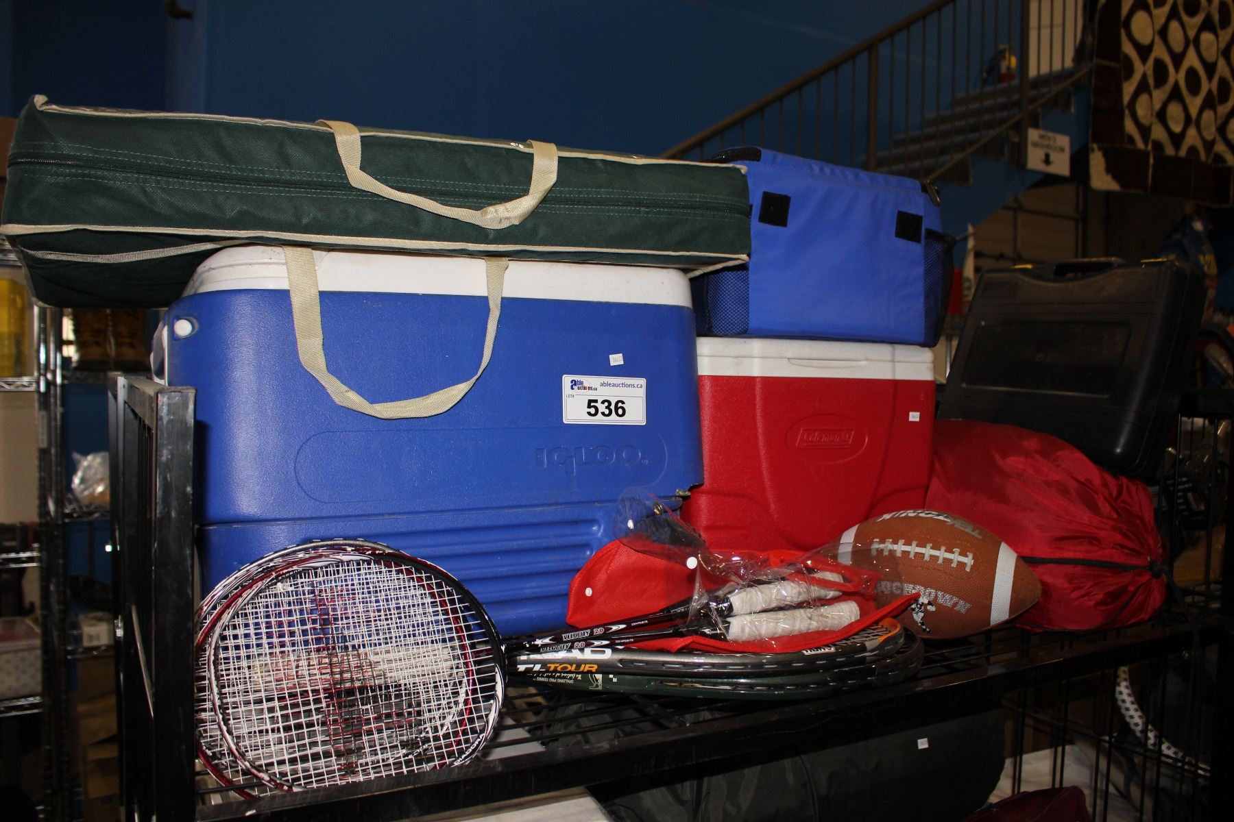 SHELF LOT OF ASSORTED COOLERS, BADMINTON & TENNIS RACKETS & PROPANE COOKTOP