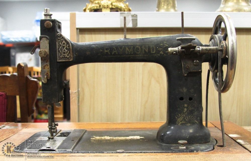 ANTIQUE RAYMOND TREADLE SEWING MACHINE.