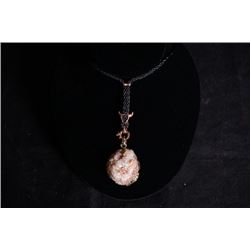 A crystal cave pendant with pendant cord.