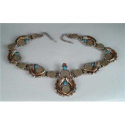 SENSATIONAL MASSIVE SILVER DOLLAR TURQUOISE AND CLAW NECKLACE BY JOHN YELLOWHORSE.