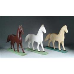SET OF SIX CARVED WOOD HORSES ON FLAT STANDS.  