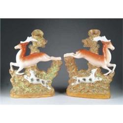 PAIR OF STAFFORDSHIRE DEER SPILL VASES.
