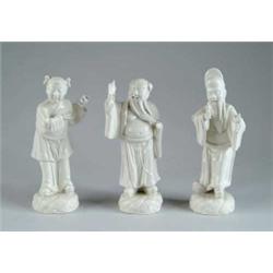 SET OF THREE WHITE ORIENTAL FIGURINES.