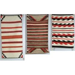 THREE NAVAJO RUGS.