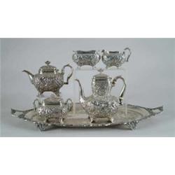 OUTSTANDING FIVE PIECE REPOUSSE TEA SET BY WHITING CO WITH SILVER PLATED TRAY.
