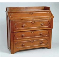 WALNUT THREE-DRAWER SLANT FRONT DESK.