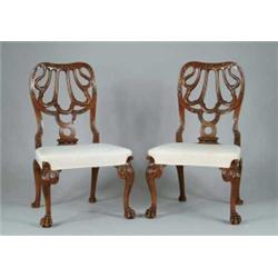 PAIR OF REPRODUCTION FANCY CARVED CHIPPENDALE SIDE CHAIRS.