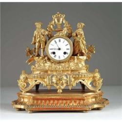 GILT METAL FIGURAL MANTEL CLOCK ON WOOD STAND.