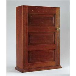 WALNUT PANELED DOOR MEDICINE CABINET.