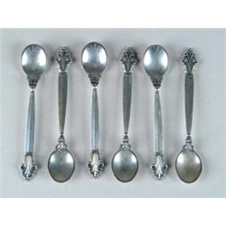 SIX GEORGE JENSEN SALT SPOONS IN THE “ACANTHUS” PATTERN.