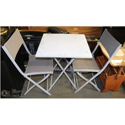 GRAY PATIO TABLE AND TWO FOLDING CHAIRS.