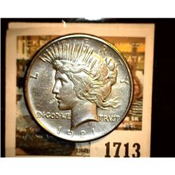 1713 _ 1921 P U.S. Silver Peace Dollar, Choice VF. Small obverse planchet defect. Gold toning.