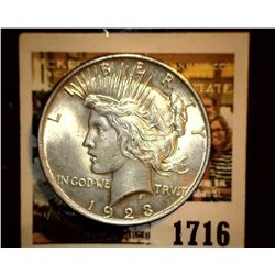 1716 _ 1923 P U.S. Silver Peace Dollar, Choice BU 64. Gold toning.