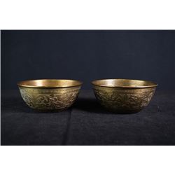 A pair of copper bowls.