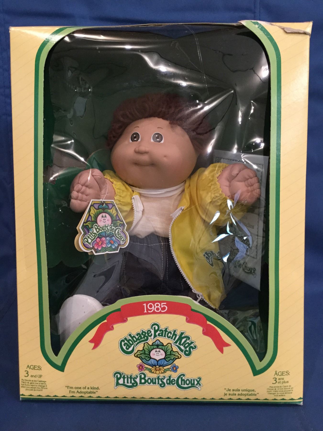 Cabbage Patch Doll in box marked 1985 P'tits Bouts de Choux and has