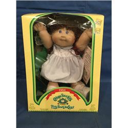 Cabbage Patch Doll in box marked 1984 P'tits Bouts de Choux and has certificate
