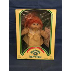 Cabbage Patch Doll in box marked 1984 P'tits Bouts de Choux and has certificate
