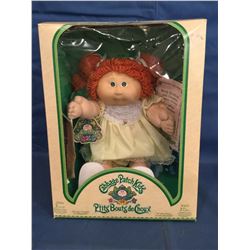 Cabbage Patch Doll in box marked 1985 P'tits Bouts de Choux and has certificate