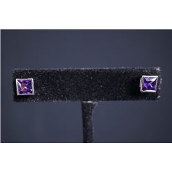 A pair of woman's earrings with amethyst.