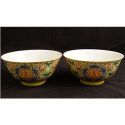 A pair of yellow ground famille rose bowls.