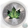 Image 1 : 2014 Canada 1oz .9999 Fine Silver Coloured Green Maple Leaf (capsule scuffed & Coin lightly toned). 