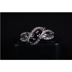 A silver ring inlaid with black diamond.