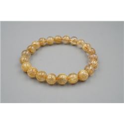 A natural rutilated quartz golden hair bead bracelet.