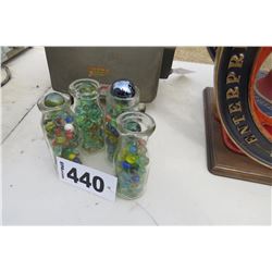 4 CREAMER BOTTLES WITH MARBLES