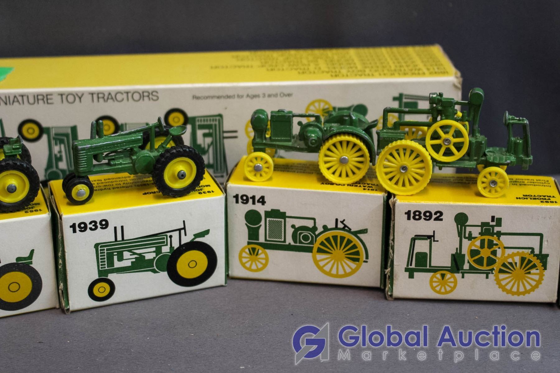 Set of (8) John Deere Miniature Metal Toy Tractors (all in Box)