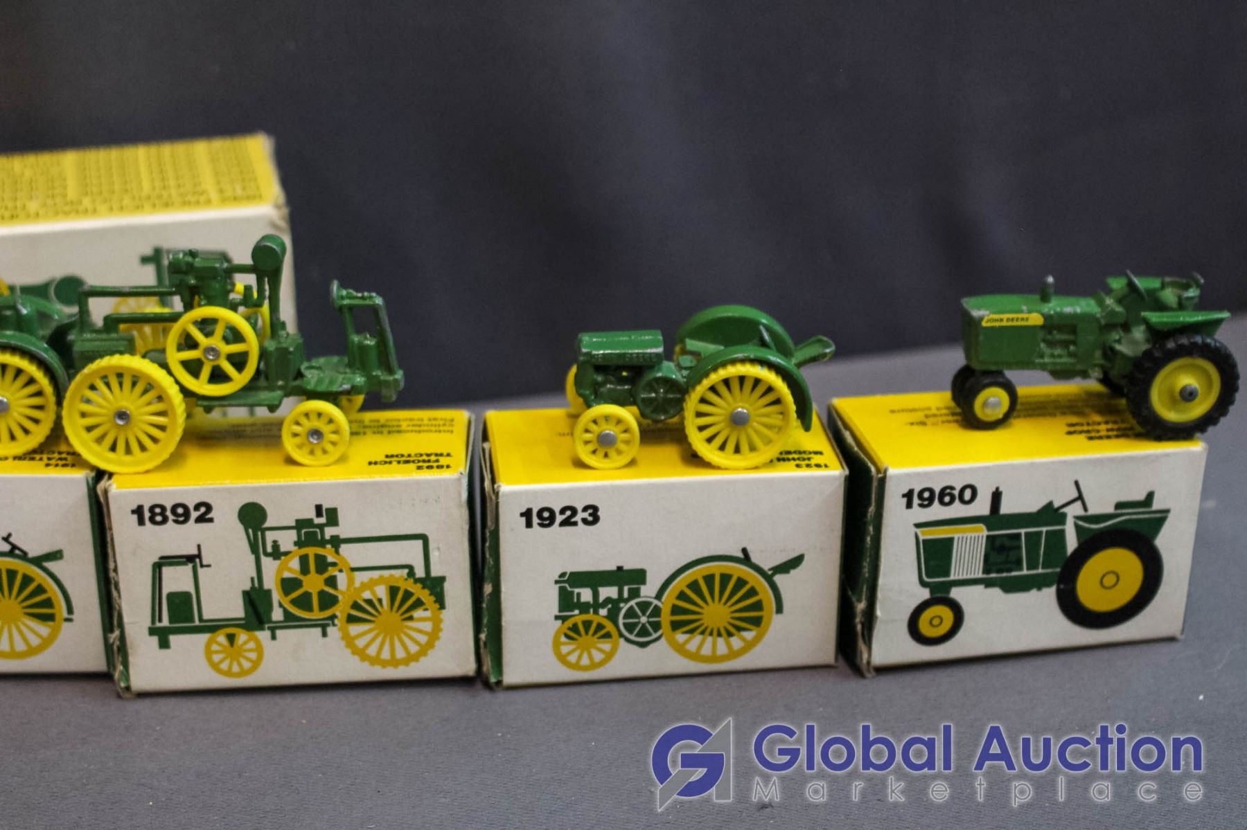Set of (8) John Deere Miniature Metal Toy Tractors (all in Box)