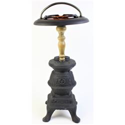 Pot belly stove floor ashtray with glass insert.