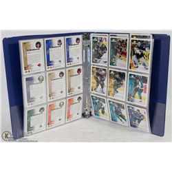 BINDER OF ASSORTED HOCKEY CARDS.