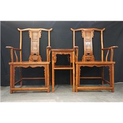 A pair of two armchairs with a small table.