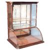 Image 1 : Single tower curved glass countertop showcase, walnut w/German Silver corners, 28"W x 35"H.