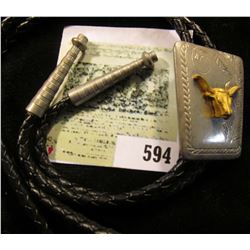 Western Style Bolo Tie with Golden Steer on engraved background.