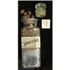 Image 1 : Large 10" x 3 1/4 Apothcary Jar with glass Stopper, some contents included.  Labeled "Myristica".  A